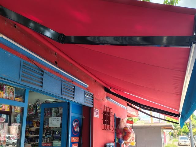 Toldo punto recto rojo en el frente de un kiosco